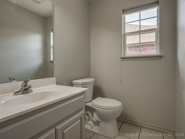 bathroom featuring toilet, vanity, and tile patterned floors