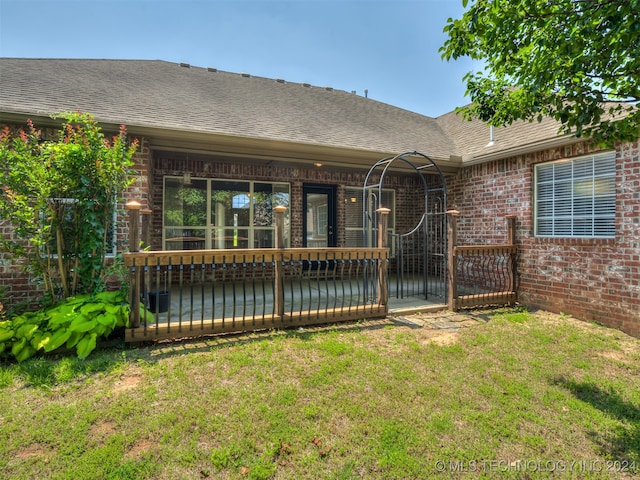 rear view of house featuring a yard