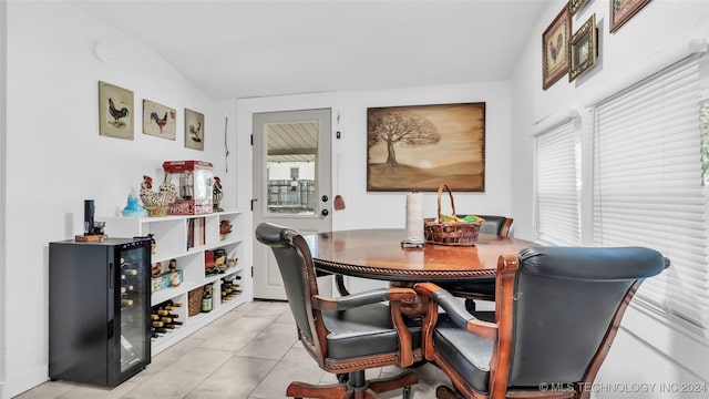 tiled dining space featuring lofted ceiling