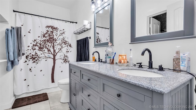 bathroom featuring tile patterned floors, curtained shower, vanity, and toilet