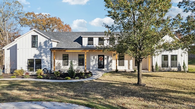 modern farmhouse style home featuring a front yard and a porch