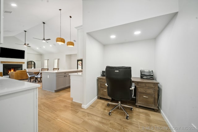 office area featuring ceiling fan, light wood-type flooring, and high vaulted ceiling