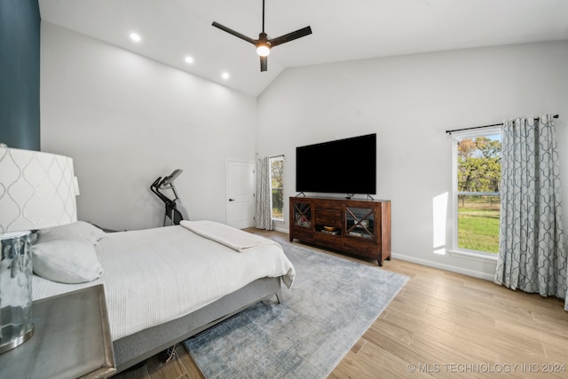 bedroom featuring ceiling fan, high vaulted ceiling, and light hardwood / wood-style floors