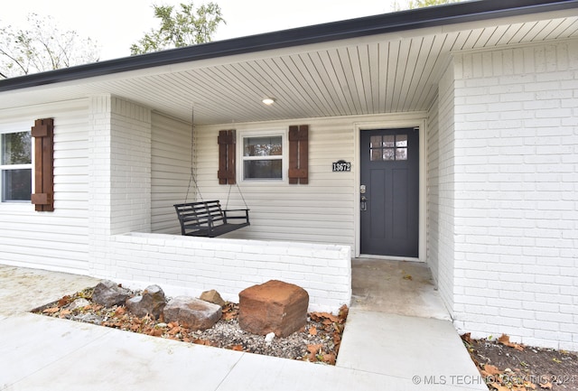 doorway to property with covered porch