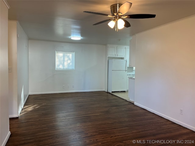 spare room with ceiling fan, crown molding, and dark wood-type flooring