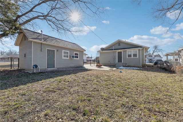 rear view of property featuring a yard