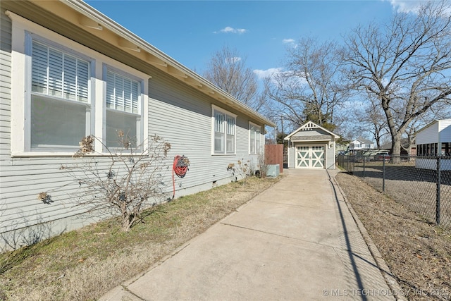 view of property exterior with a garage and an outbuilding