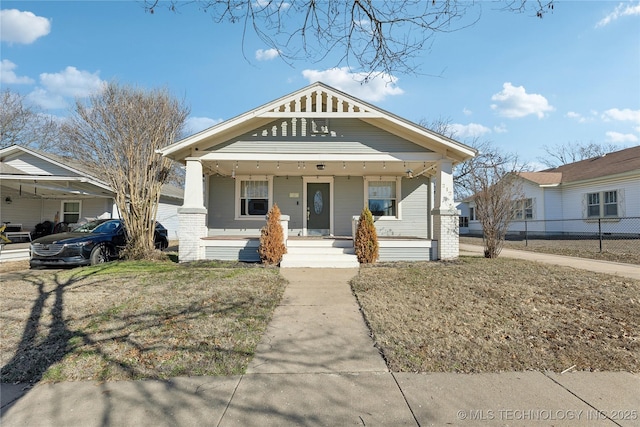 bungalow-style home featuring a front lawn and a porch