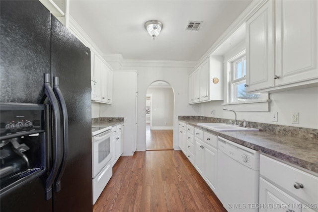 kitchen with dark hardwood / wood-style floors, sink, white cabinets, and white appliances