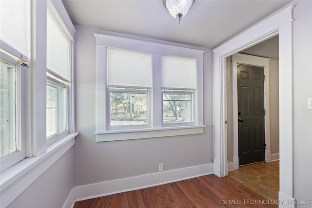 unfurnished room with dark hardwood / wood-style floors