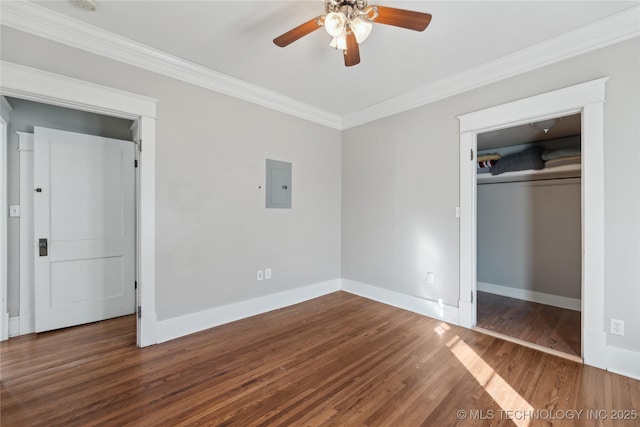 unfurnished bedroom with ceiling fan, electric panel, dark wood-type flooring, ornamental molding, and a closet