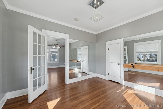 spare room featuring plenty of natural light, dark hardwood / wood-style floors, crown molding, and french doors