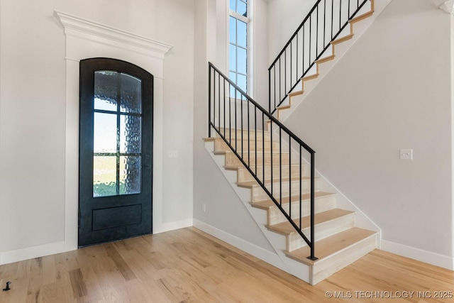 17537 S 56th E Ave, Bixby, OK 74008 - foyer entrance with wood finished floors, baseboards, stairs, arched walkways, and a high ceiling