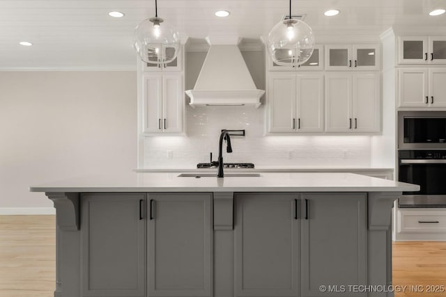 17537 S 56th E Ave, Bixby, OK 74008 - kitchen with stainless steel appliances, premium range hood, ornamental molding, light countertops, and white cabinetry