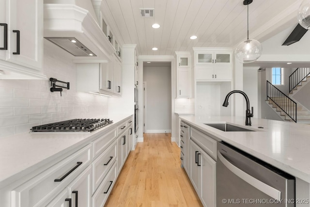 17537 S 56th E Ave, Bixby, OK 74008 - kitchen featuring stainless steel appliances, a sink, custom range hood, recessed lighting, and white cabinetry