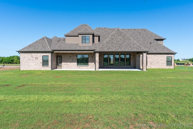 17537 S 56th E Ave, Bixby, OK 74008 - back of property with a lawn, brick siding, roof with shingles, and a patio