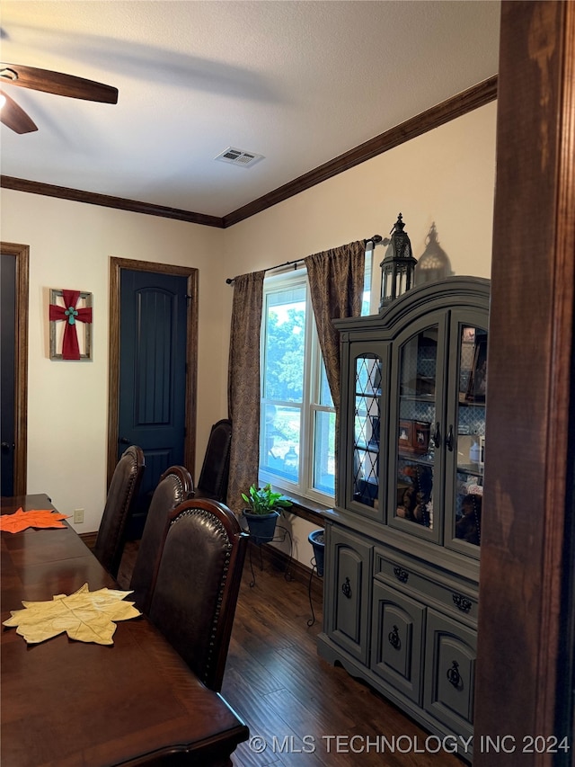 dining space with a textured ceiling, dark hardwood / wood-style floors, ceiling fan, and crown molding