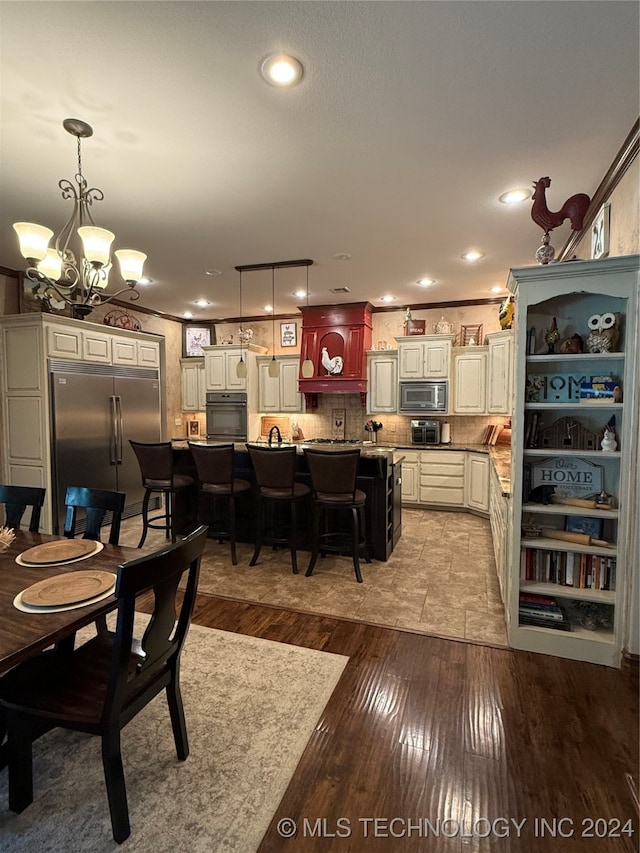 dining area with a chandelier and light hardwood / wood-style floors