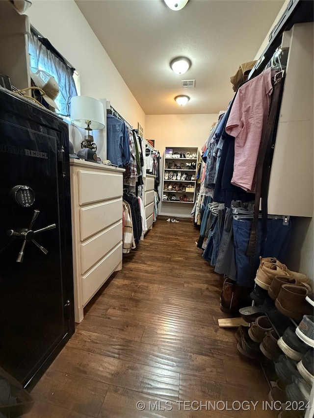 spacious closet featuring dark hardwood / wood-style flooring