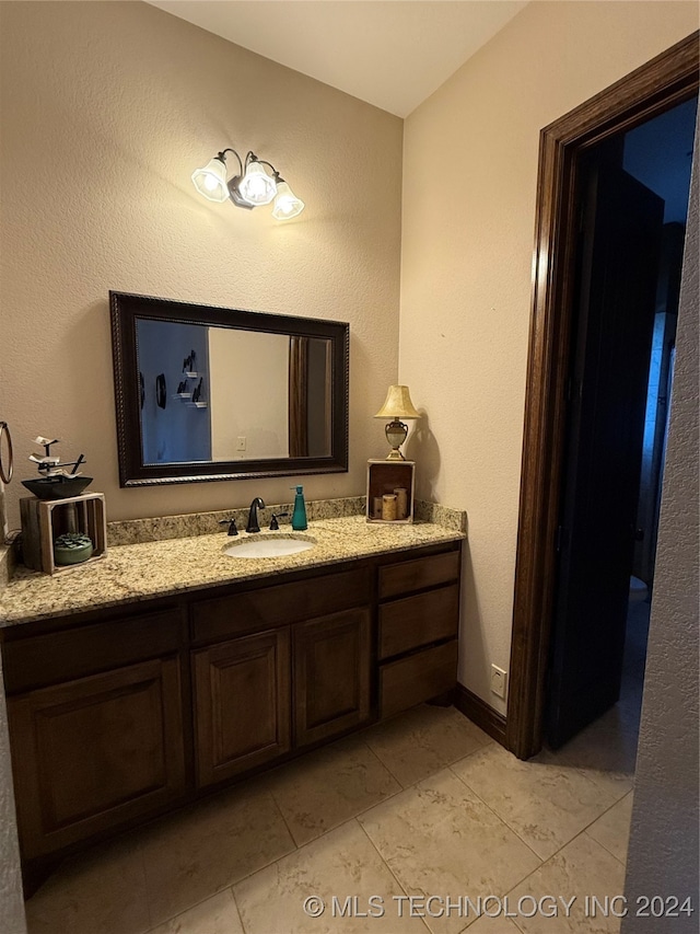 bathroom with tile patterned flooring and vanity