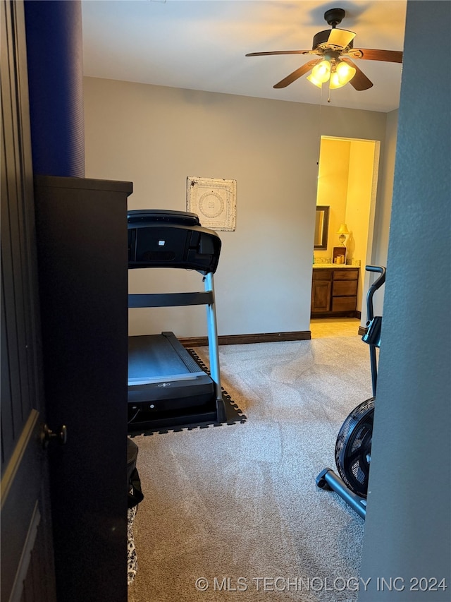 exercise area featuring ceiling fan and carpet floors