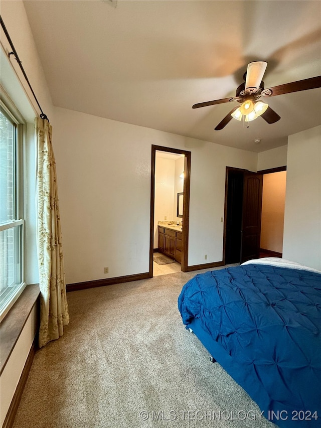 unfurnished bedroom featuring ceiling fan, light colored carpet, and ensuite bathroom