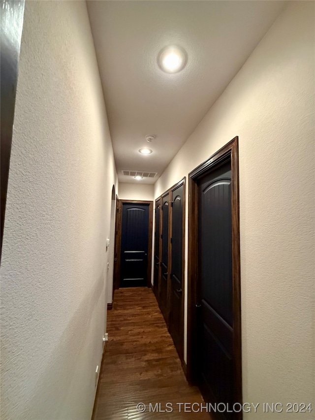 hall with dark hardwood / wood-style flooring