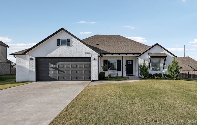 view of front of home featuring a front yard and a garage