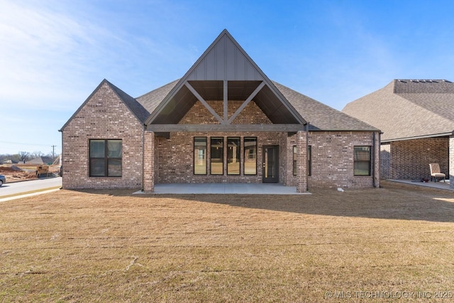 2708 W Van Buren Ct, Broken Arrow, OK 74134 - back of property featuring brick siding, a yard, a patio area, and board and batten siding