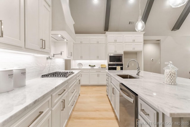 2708 W Van Buren Ct, Broken Arrow, OK 74134 - kitchen featuring stainless steel appliances, white cabinets, backsplash, light wood-type flooring, and custom range hood