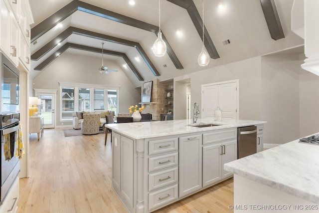 2708 W Van Buren Ct, Broken Arrow, OK 74134 - kitchen featuring appliances with stainless steel finishes, a ceiling fan, light wood finished floors, white cabinetry, and light stone countertops