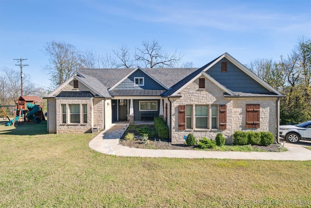 craftsman-style home featuring a playground and a front yard