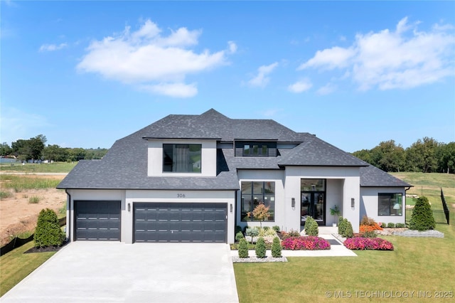 view of front of house featuring a front lawn and a garage