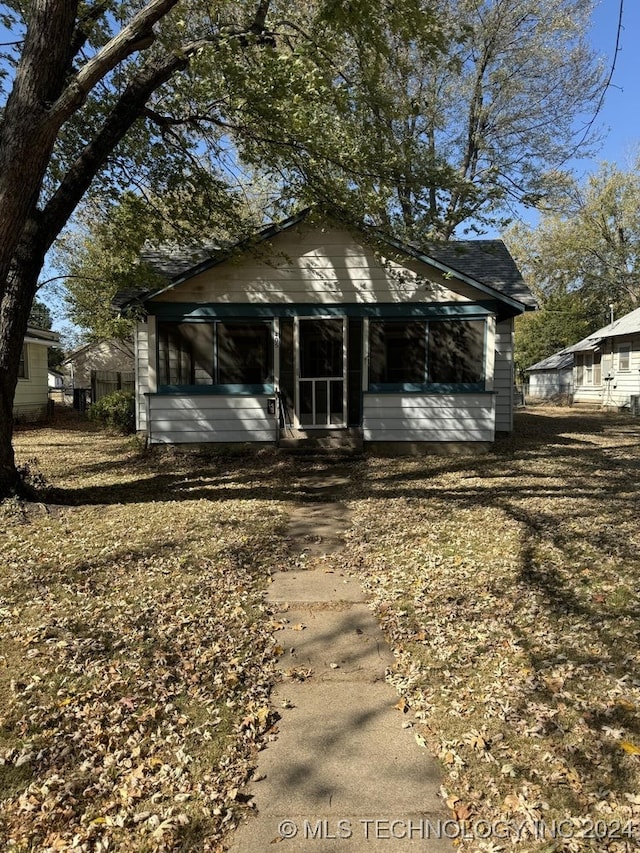 rear view of house with a sunroom