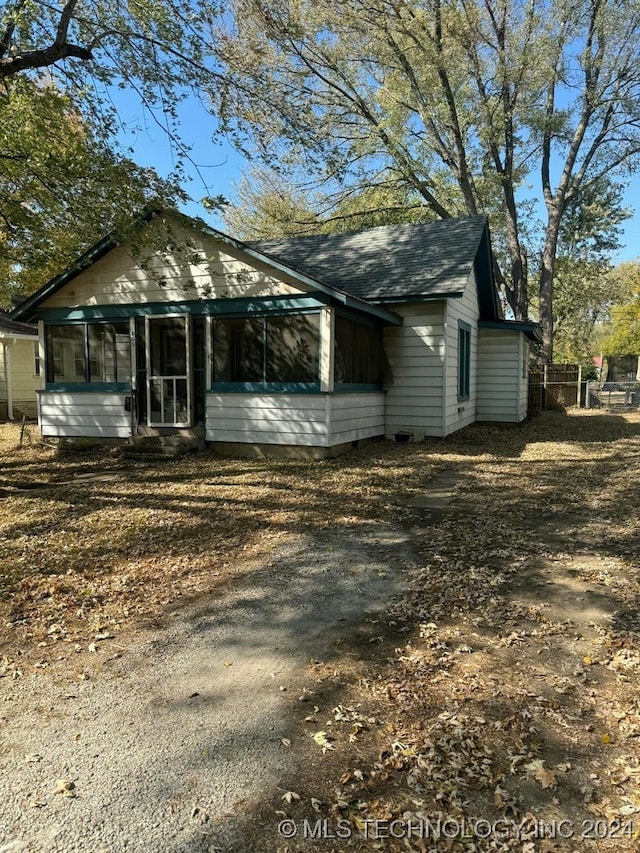 view of front of home with a sunroom