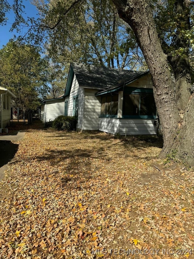 view of side of property featuring a sunroom