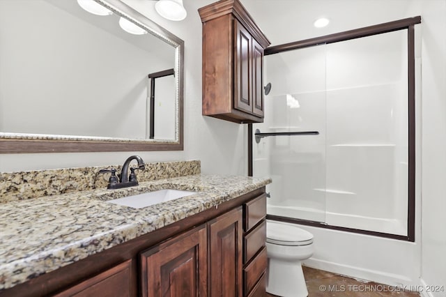 full bathroom featuring tile patterned floors, vanity, enclosed tub / shower combo, and toilet