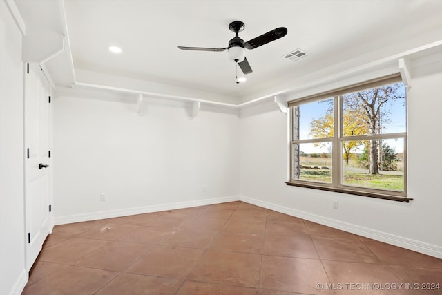 empty room featuring tile patterned floors and ceiling fan