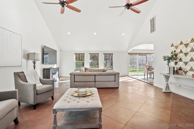 tiled living room with high vaulted ceiling and ceiling fan