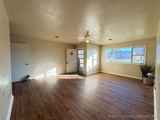 interior space featuring a textured ceiling, dark hardwood / wood-style floors, and ceiling fan