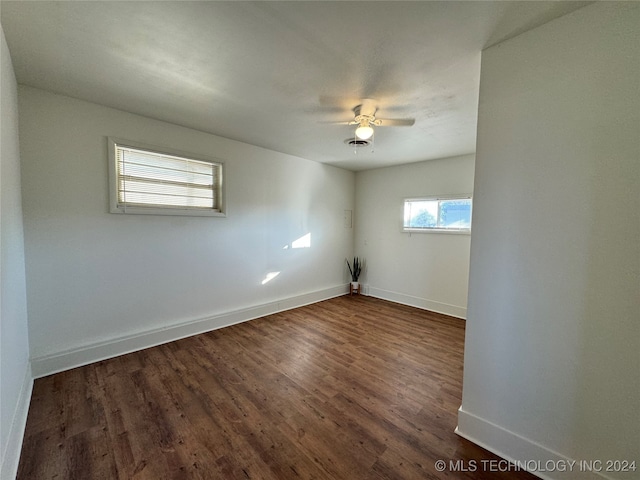 empty room featuring ceiling fan and dark wood-type flooring