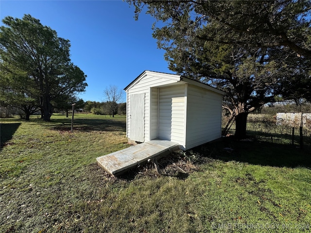 view of outbuilding featuring a yard