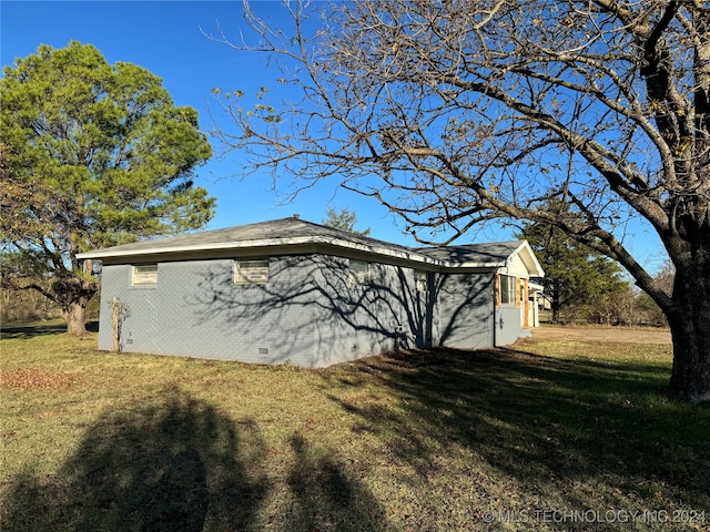 view of side of property with a yard