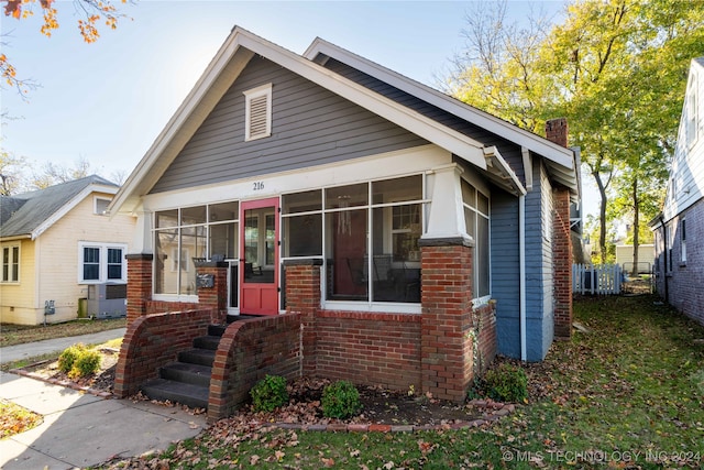 view of front facade with a sunroom