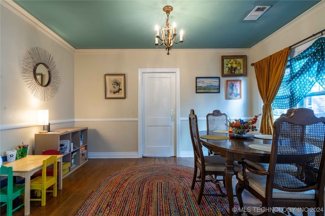 dining room featuring dark hardwood / wood-style flooring, a chandelier, and ornamental molding