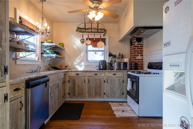 kitchen featuring white appliances, dark wood-type flooring, sink, wall chimney range hood, and hanging light fixtures