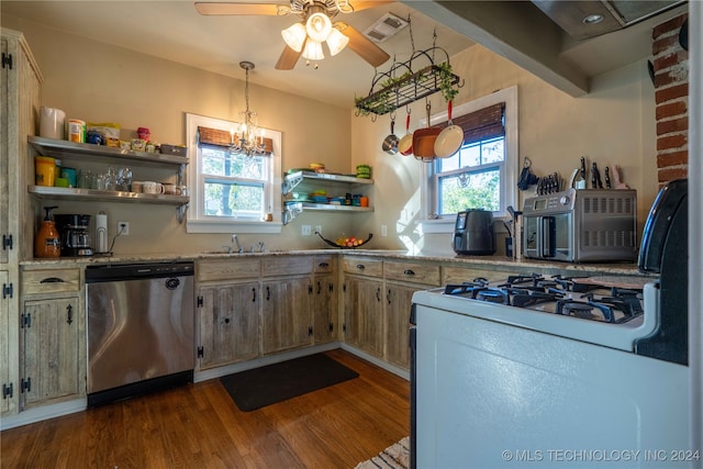 kitchen featuring pendant lighting, ceiling fan with notable chandelier, stainless steel dishwasher, light stone counters, and wood-type flooring