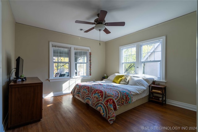 bedroom with ceiling fan, crown molding, and dark hardwood / wood-style floors