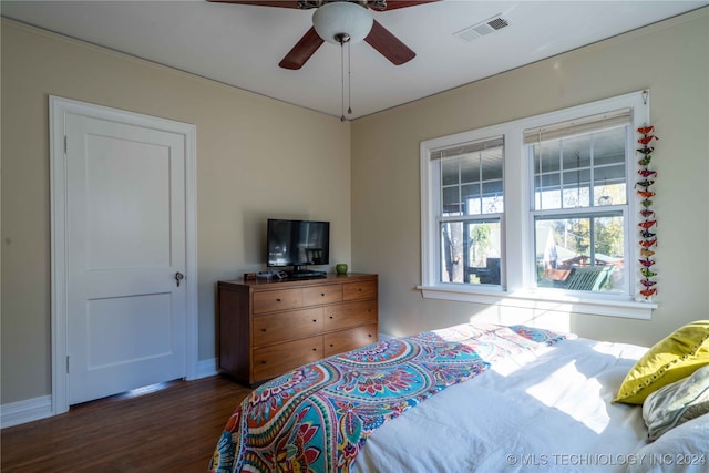 bedroom with ceiling fan and dark hardwood / wood-style flooring