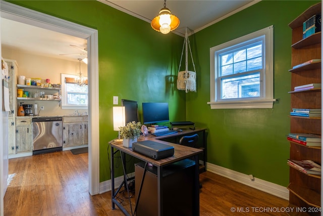 home office with ceiling fan with notable chandelier, crown molding, and dark wood-type flooring